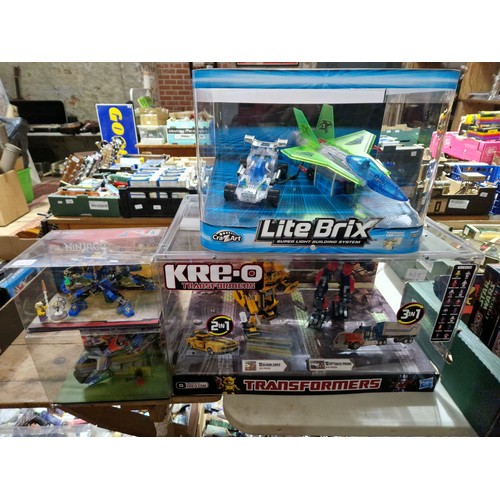 428 - Four boxed toys comprising a Lite Brix car & plane in display box, a Kre-o Transformers display box ... 