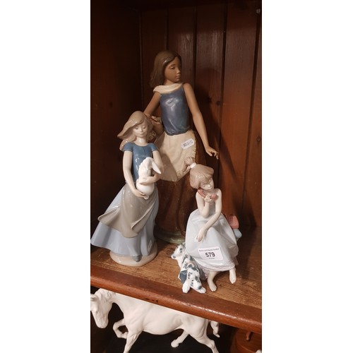 579 - Lladro figure of a girl on the phone and two Nao figures