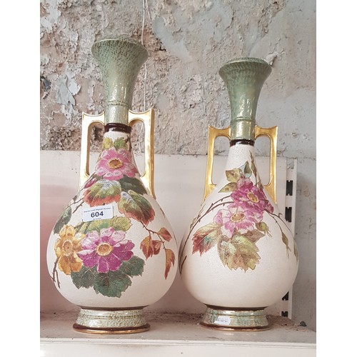 604 - A pair of Bonn twin handled vases, floral and gilt decoration.