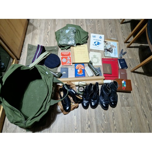 227 - A military kit bag and contents including boots, knives, torches etc. etc.