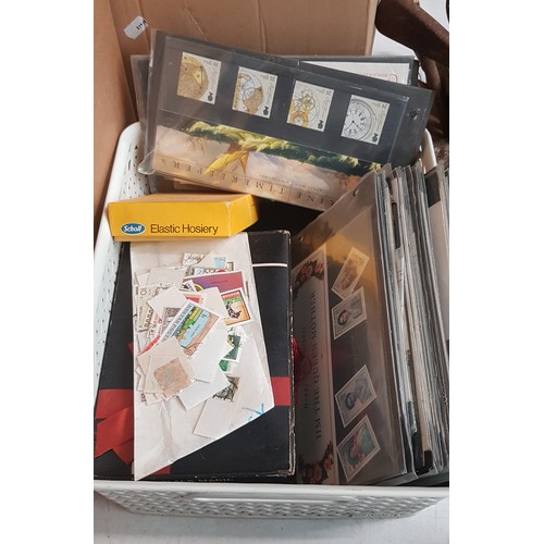 263 - A box containing a stamp album, assorted loose stamps and first day covers.