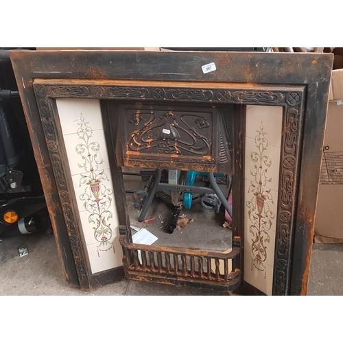 267 - An Art Nouveau cast metal fireplace insert with original tiles..