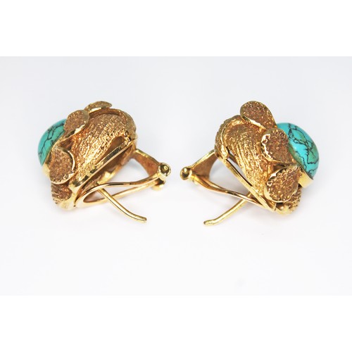 50 - A pair of turquoise earrings, each of flower form set with a turquoise cabochon and surrounded by te... 
