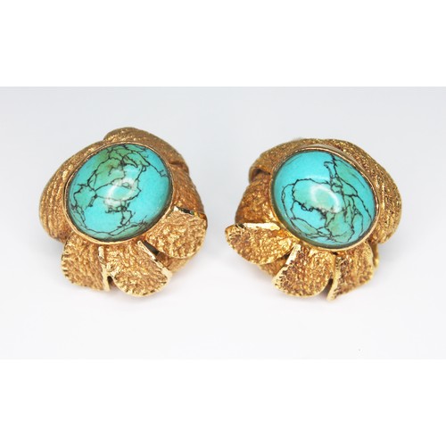 50 - A pair of turquoise earrings, each of flower form set with a turquoise cabochon and surrounded by te... 