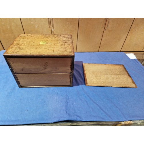 447 - A 19th century oak cabinet with two drawers and campaign style handles.
