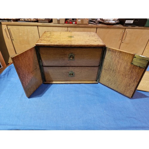 447 - A 19th century oak cabinet with two drawers and campaign style handles.