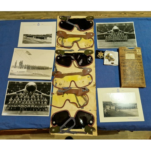 214 - A mixed lot of mainly cap badges etc, together with eye shield goggles and buttons, photographs.