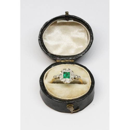 14 - An Art Deco emerald and diamond ring, the central rectangular emerald measuring approx. 4.2mm x 3.9m... 