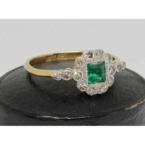 14 - An Art Deco emerald and diamond ring, the central rectangular emerald measuring approx. 4.2mm x 3.9m... 