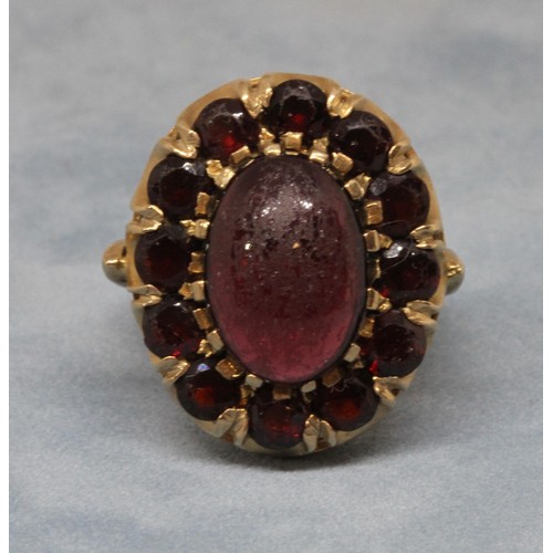 25 - A garnet cluster ring, the oval cluster measuring approx. 23mm x 19mm, marked '9c', gross weight 8.7... 