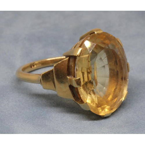 26 - An Art Deco style citrine ring, the central oval mixed cut stone weighing approx. 13cts, band indist... 