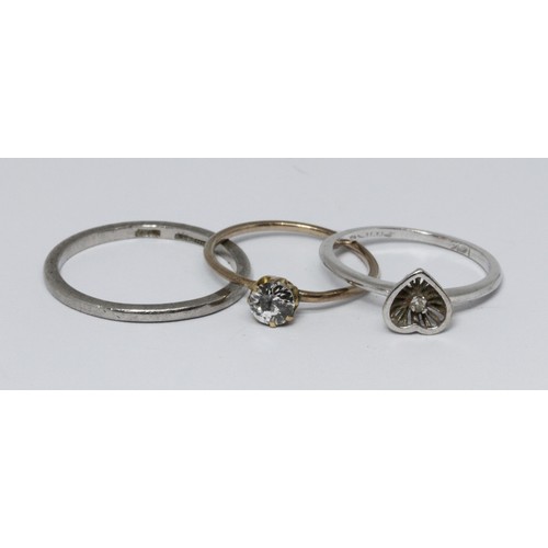 45 - Three rings; a band marked 'Platinum' weight 3g, a single stone diamond ring unmarked weight 1g and ... 