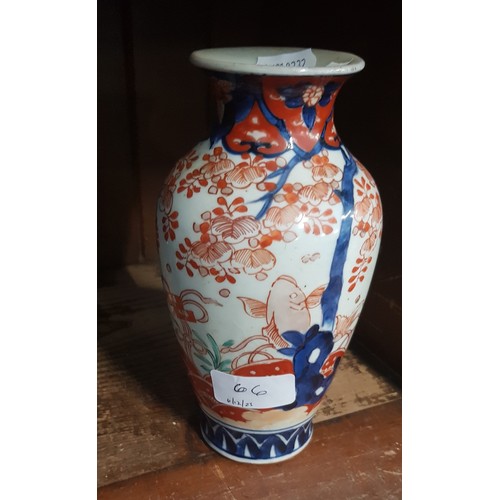 66 - An oriental vase, decorated with fish.