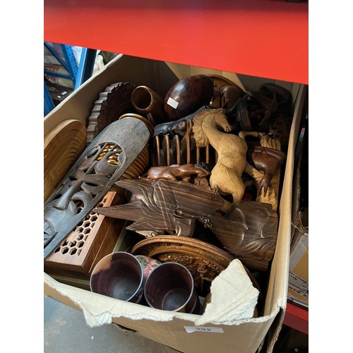 392 - A box of treen including carved wood animals, African items, etc.