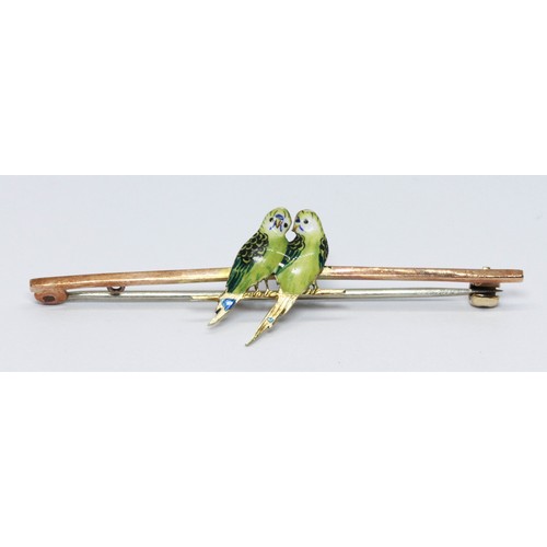 184 - A novelty bar brooch mounted with enamel budgies, marked '9ct', gross weight 2.9g, length 55mm.