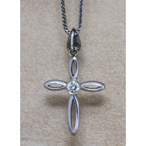 187 - A single stone diamond cross pendant, unmarked, length 35mm, on white metal snake link chain with lo... 