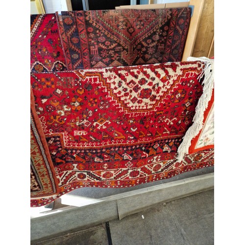 1071 - An Iranian hand knotted wool carpet, red ground. Appx 210cm x 168cm