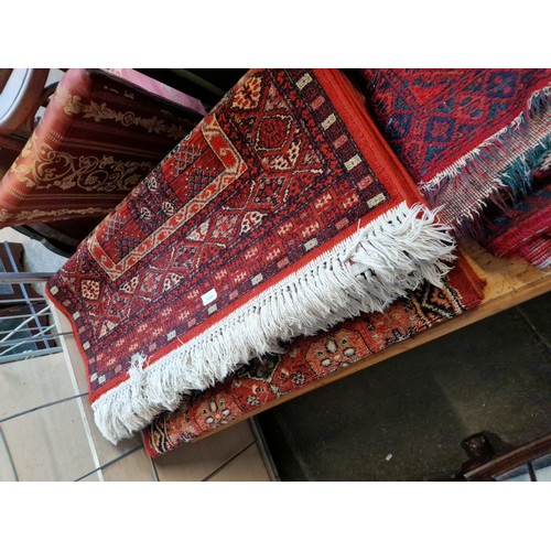 1086 - Three eastern style red ground wool carpets