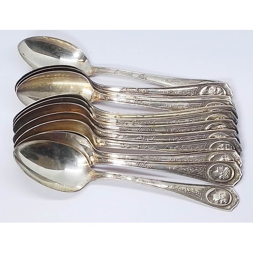 243 - A set of twelve Oneida Movie Star spoons together with two hallmarked silver handled cheese knives.