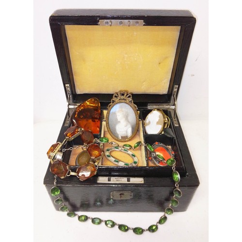 246 - An antique leather bound jewellery box and contents including a miniature portrait, amber jewellery,... 