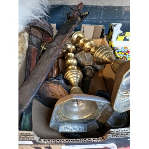 104 - A box of metalware including brass candle sticks, 3 small pewter jugs, set of 3 copper measuring jug... 