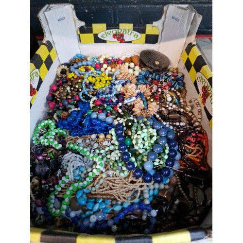 107 - A box of costume jewellery including beads, necklaces, etc.