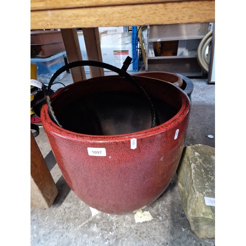 1097 - Four planters, one blue glazed, one red glazed and two terracotta, together with a metal stand.