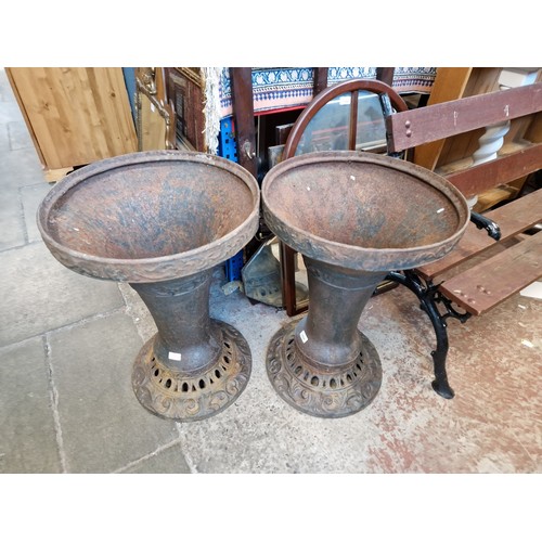 1094 - Two large cast iron garden planters.