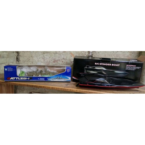 383 - A boxed  R/C stinger boat & a Boxed R/C HT-3827 Battleship 1/360 Scale.