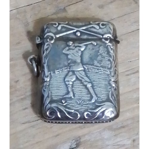 306 - A vesta case decorated with a golfer, marked 'Sterling'.