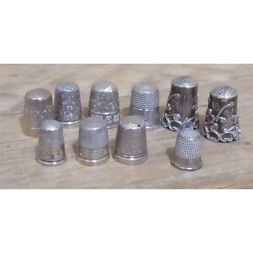 293 - Ten assorted hallmarked silver and white metal thimbles.