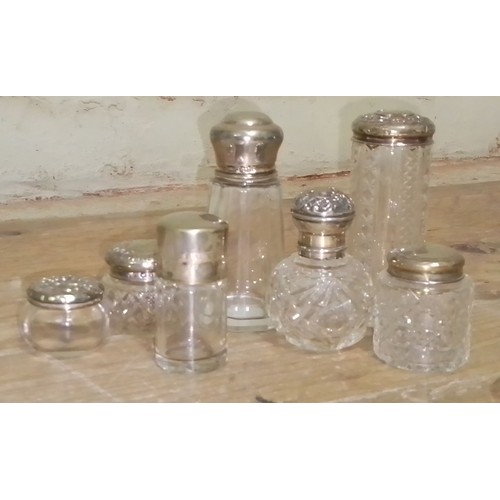 296 - A collection of hallmarked silver topped glass ware.