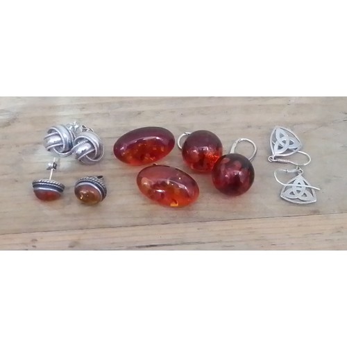 330 - Three pairs of silver and amber earrings and two other pairs of silver earrings.