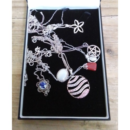 370 - Assorted mainly silver pendants on chains.