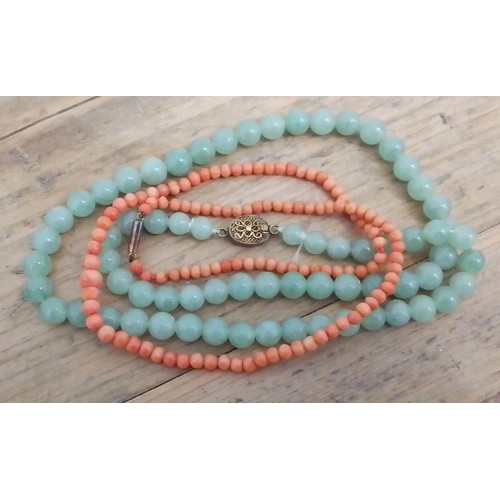 332 - A jadeite jade bead necklace and a coral necklace with clasp marked '9c'.