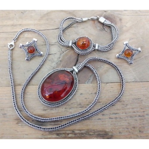 328 - A suite of Polish silver and amber jewellery by Beata Bielak, comprising an amber cabochon pendant o... 