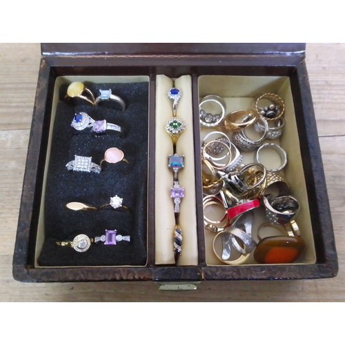 379 - An embossed jewellery box containing costume rings.