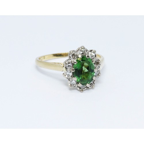 413 - A green tourmaline and diamond ring, the band marked '18ct', gross weight 4g, size N.