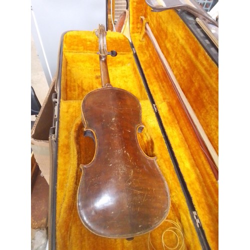 231 - An antique violin and a modern student violin.