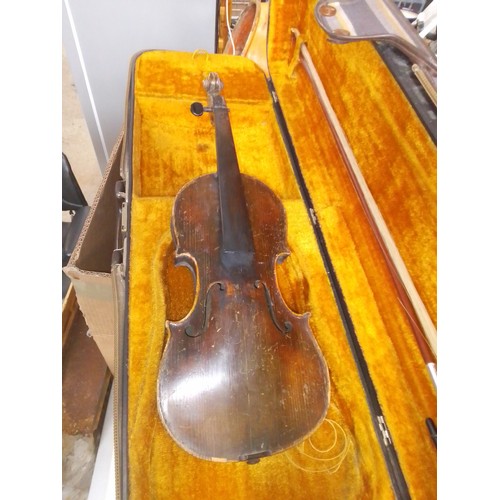 231 - An antique violin and a modern student violin.