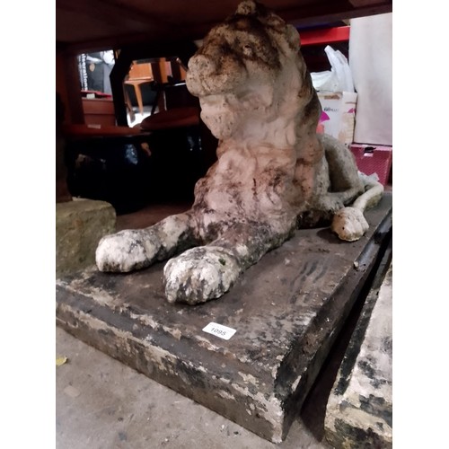 1095 - Two large stoneware recumbent lion garden ornaments.