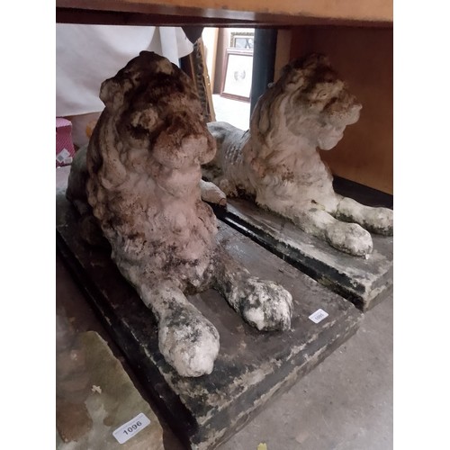 1095 - Two large stoneware recumbent lion garden ornaments.