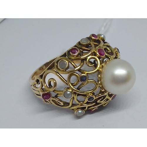 24 - A multi-gem set ring, set with a central cultured pearl, further cultured pearls, rubies and sapphir... 
