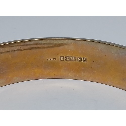 69 - A hallmarked 9ct gold bangle, diameter 58mm, weight 19.4g.