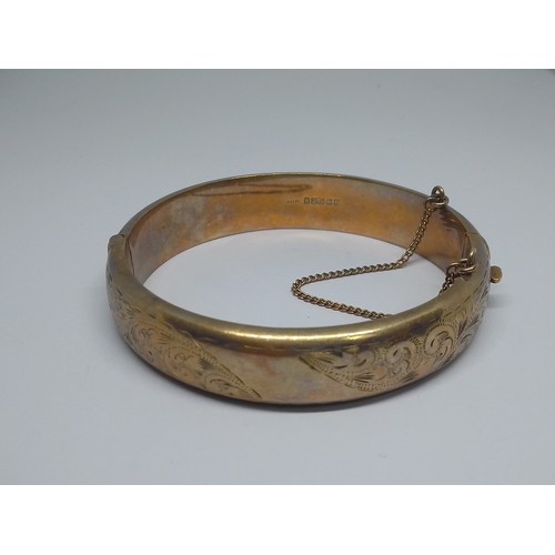 69 - A hallmarked 9ct gold bangle, diameter 58mm, weight 19.4g.