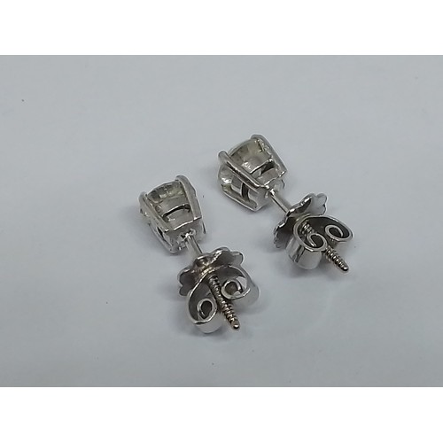 85 - A pair of diamond ear studs, each round brilliant cut stone weighing approx. 0.50cts, screw back but... 