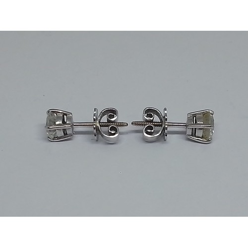 85 - A pair of diamond ear studs, each round brilliant cut stone weighing approx. 0.50cts, screw back but... 