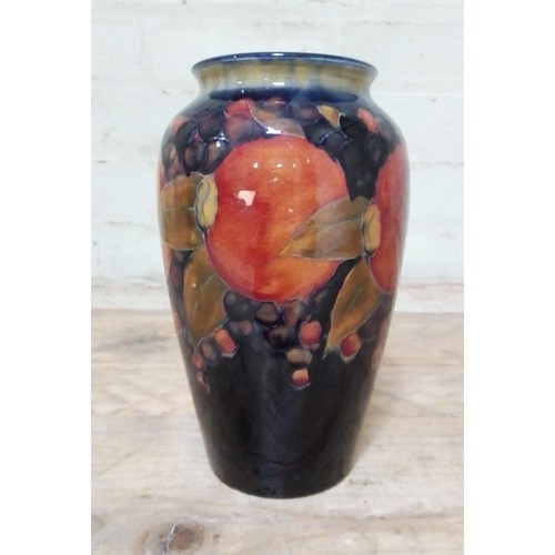 136 - A Moorcroft pottery vase, decorated in pomegranate, height 21cm.