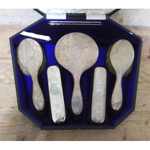 124 - A cased seven piece hallmarked silver dressing table set.