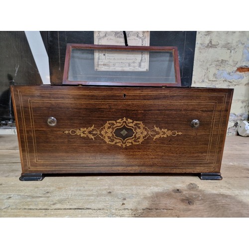 138 - A 19th century Swiss music box, six airs, playing on combs and reed organ, cabinet length 62cm.